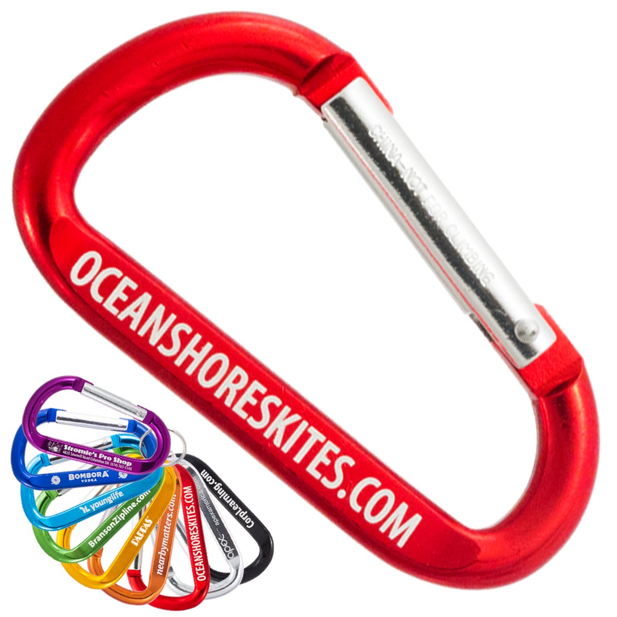 Red custom engraved carabiner keychain on a white background with a smaller grouping of other color carabiners in the lower left corner