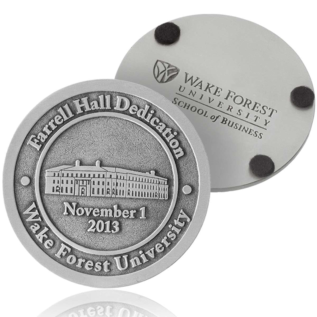 Two pewter coasters with text and a building illustration, featuring Wake Forest University branding.