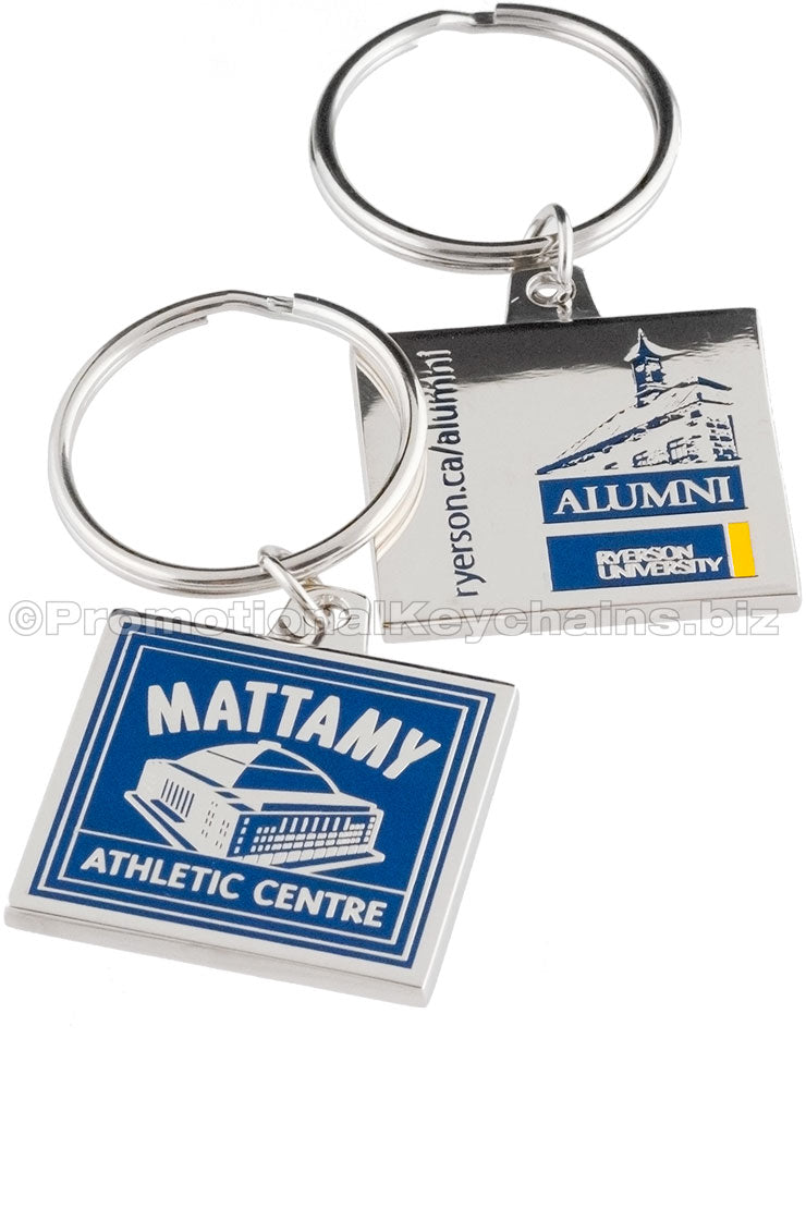 Two sides of a square polished nickel keychain, featuring logos for Mattamy Athletic Centre and Ryerson University Alumni on either side in blue and yellow enamel color.