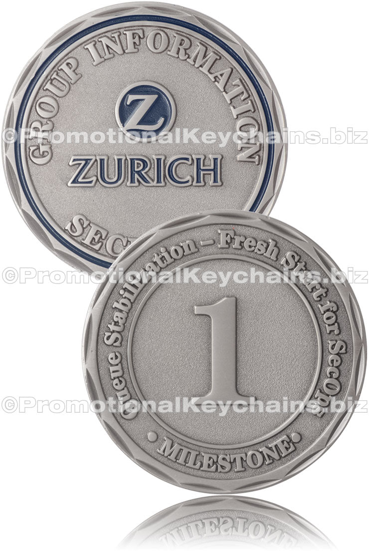 Both sides of an antiqued nickel challenge coin, featuring a "Zurich" logo in dark blue enamel color on one side and a distinct "1" in the center of the other side. The edge of the coin is cut in the petal style.