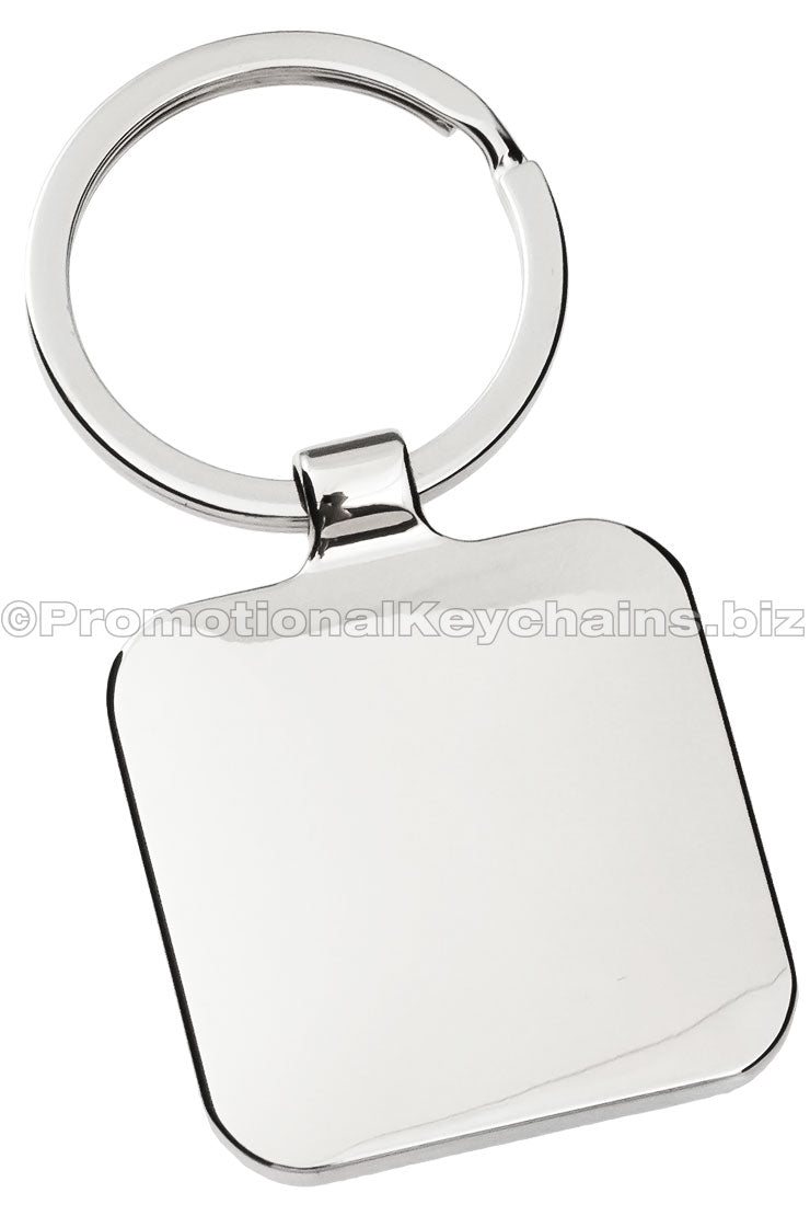 The blank back of a polished metal keychain, square in shape.