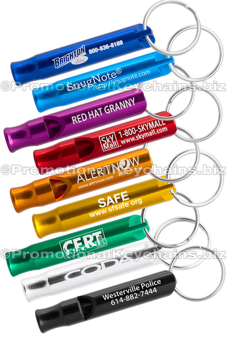 Example of the Aluminum Bobby Safety Whistle showing all the colors. Colors of whistles royal blue, aqua, purple, red, orange, gold, green, silver and black. Each has a silvery white engraving showing custom branding.