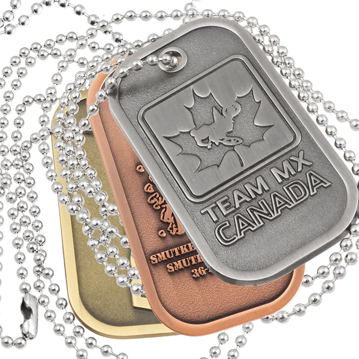 Close up of the Group of Brushed Antiqued Die Cast Dog Tags. Tags are layered on top of each other and show examples of antiqued nickel, brass and copper plating. A 30" ball chain is looped around the tags.