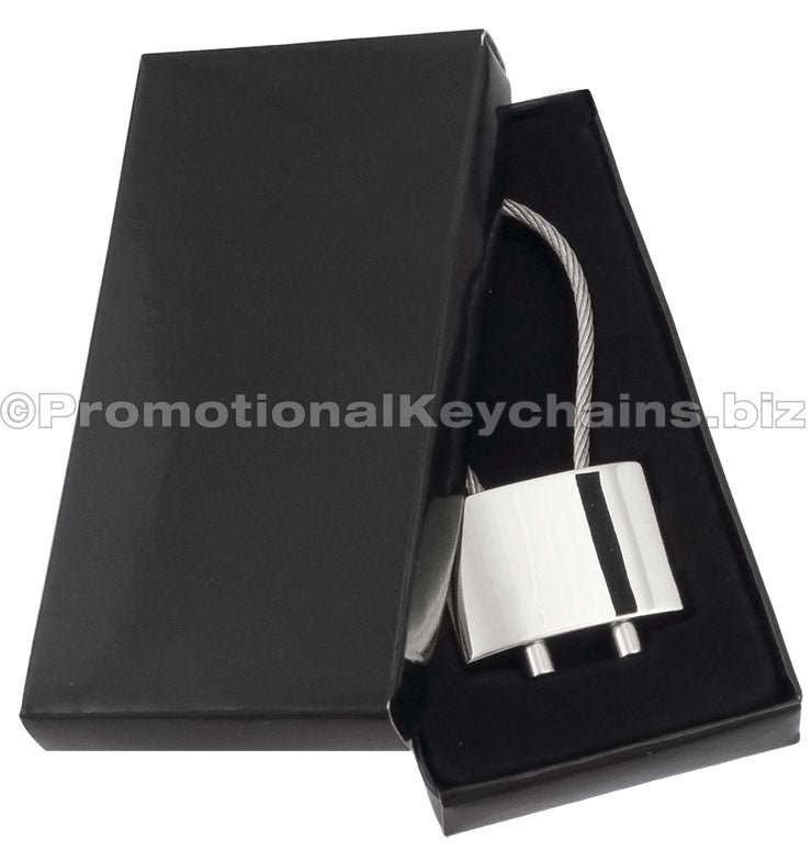 A polished metal cable keychain displayed in a black gift box.