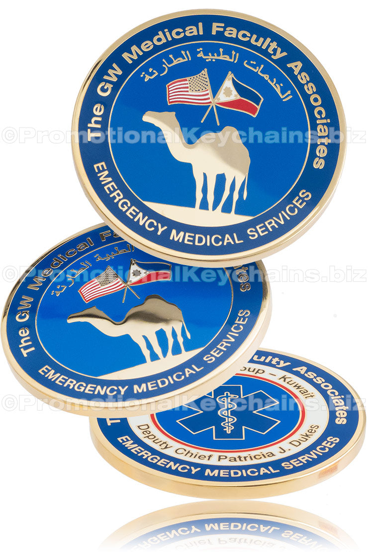 Three different angles of a polished, gold plated coin, featuring blue enamel color and imagery of a camel, flags, and an emergency medical symbol.