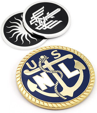 There are three different coaster designs featured. At the bottom, a polished brass coaster featuring an anchor and "USNL" text with a blue enamel color background. At the top, two polished nickel coasters placed on top of each other, each with a black enamel background and various designs in the center.