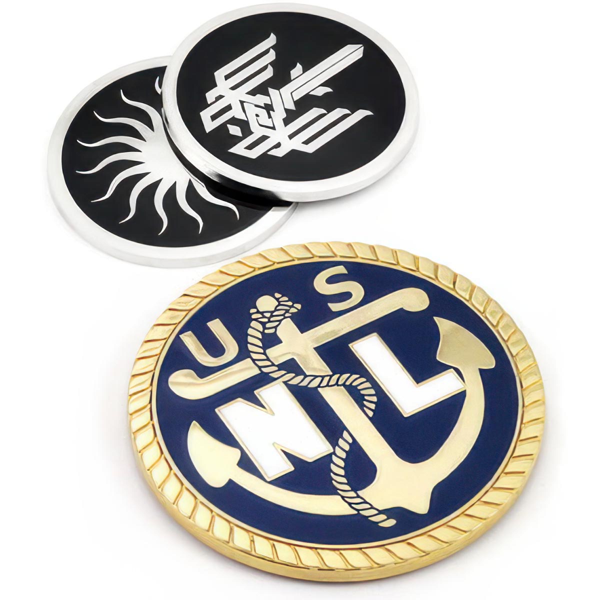 There are three different coaster designs featured. At the bottom, a polished brass coaster featuring an anchor and "USNL" text with a blue enamel color background. At the top, two polished nickel coasters placed on top of each other, each with a black enamel background and various designs in the center.