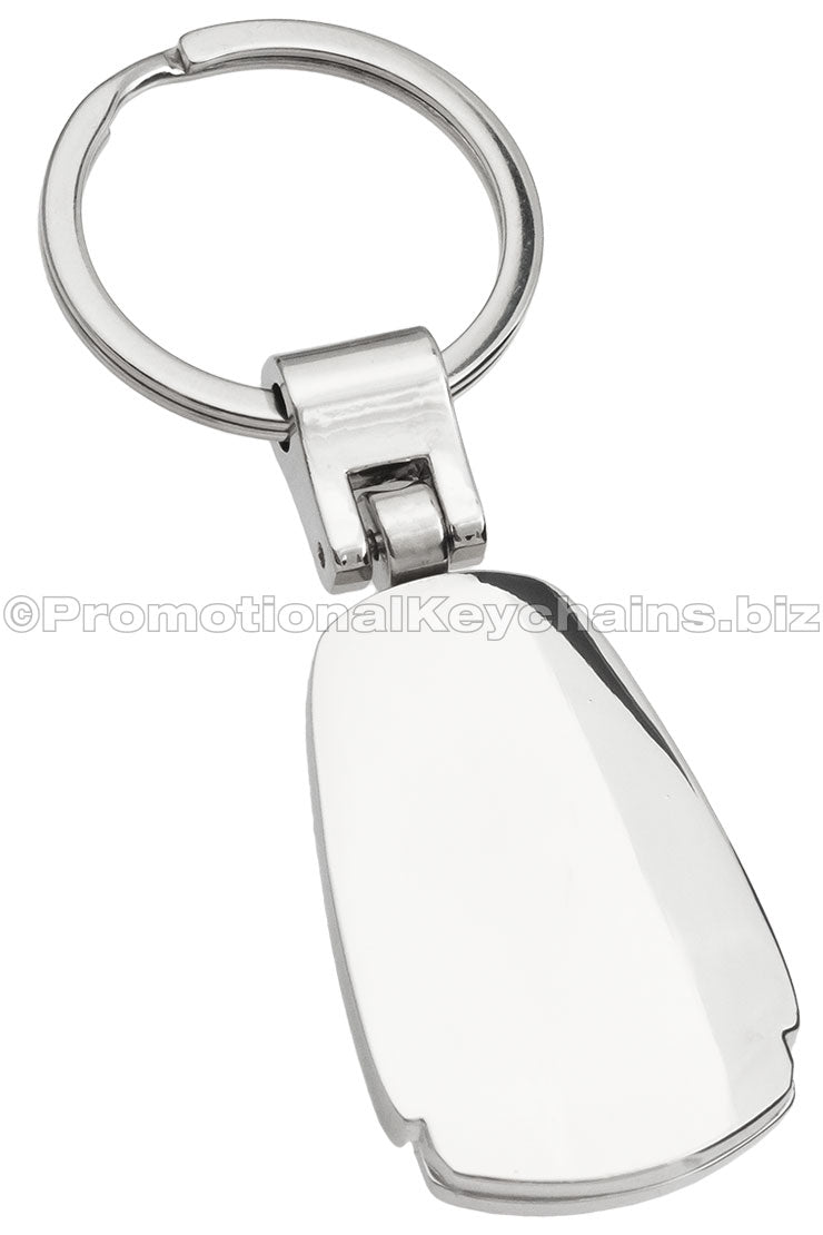 The blank back of a polished metal fob keychain.