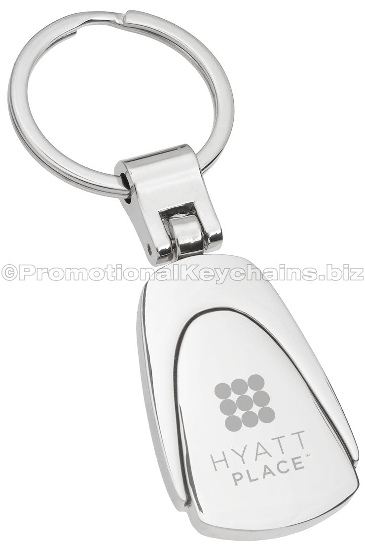 A polished metal fob-shaped keychain featuring the logo for Hyatt Place engraved in the center.