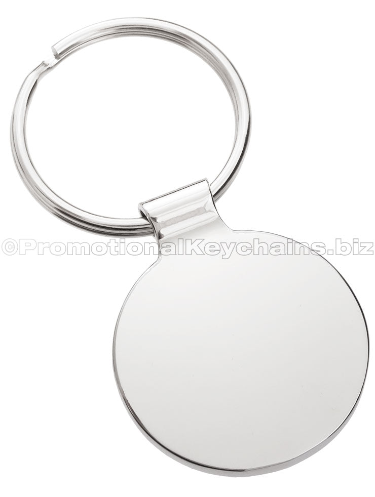 The blank back of a circular polished metal keychain.