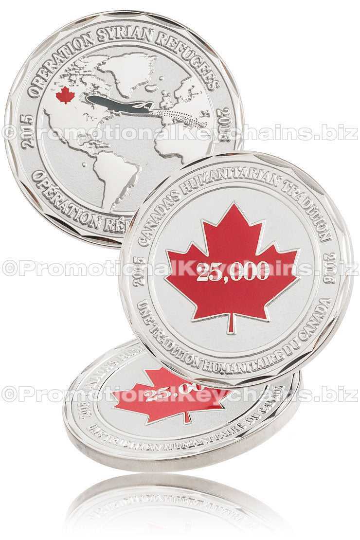 Three different angles of a polished, nickel plated commemorative coin. The front shows a world map with a plane flying from Syria to Canada, and the front has a red, hard enamel maple leaf with the number "25,000" in the center.
