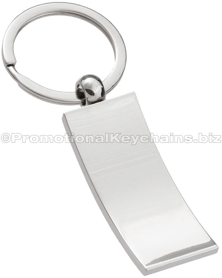 The blank back of a polished, curved metal keychain, rectangular in shape.