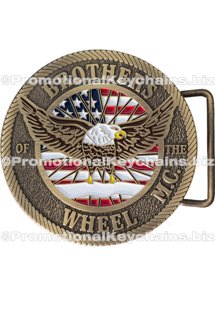 A detailed belt buckle featuring an emblem with a bald eagle in front of an American flag, showcasing intricate detail and a rope border.