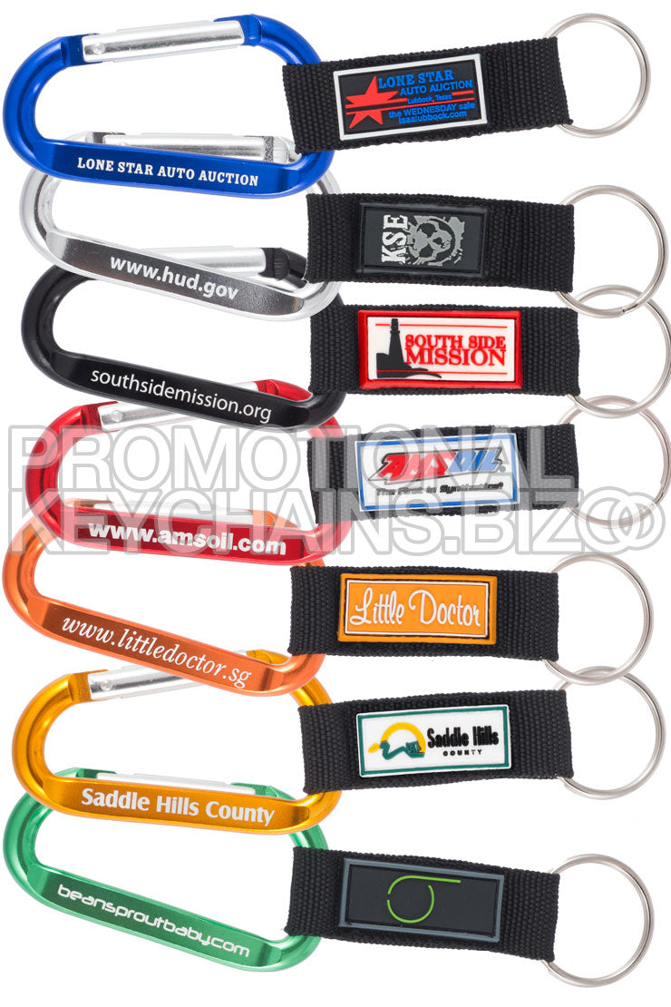 A set of multi-colored carabiner keychains with custom PVC emblems attached to nylon straps, featuring various colors and promotional text.