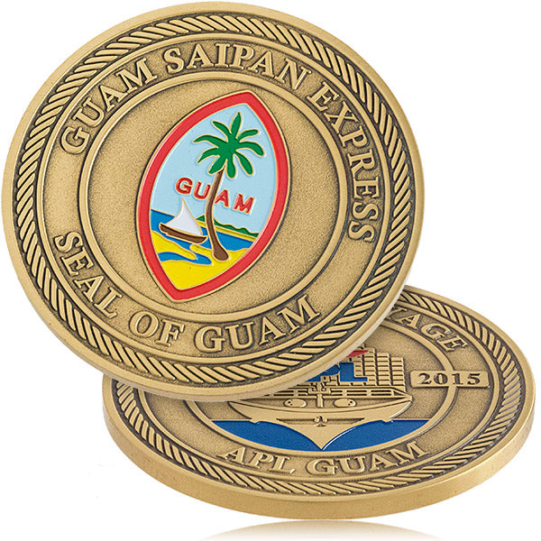 Two sides of an antiqued brass coin, featuring a multicolor Guam seal on the front and an APL ship design on the back, commemorating "Guam Saipan Express".