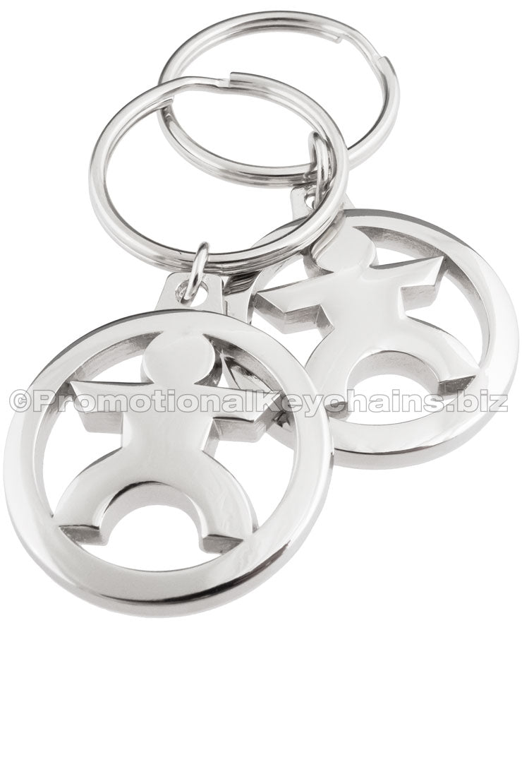 Two angles of the same polished nickel keychain featuring a cutout design of a stylized human figure in the center of a circle.