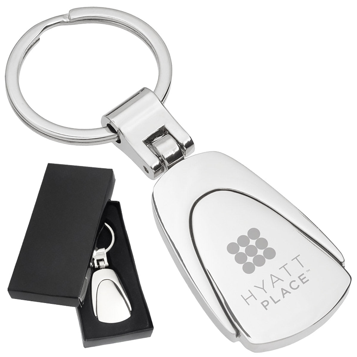 There are two images. On the left, a polished metal fob keychain displayed in a black gift box. On the right is the same keychain with a logo clearly engraved in the center.