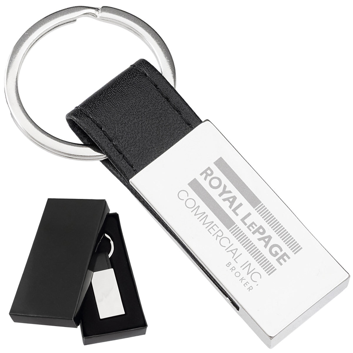 There are two images. On the left, a polished rectangular keychain with a black leather strap displayed in a black gift box. On the right is the same keychain with a logo clearly engraved in the center.
