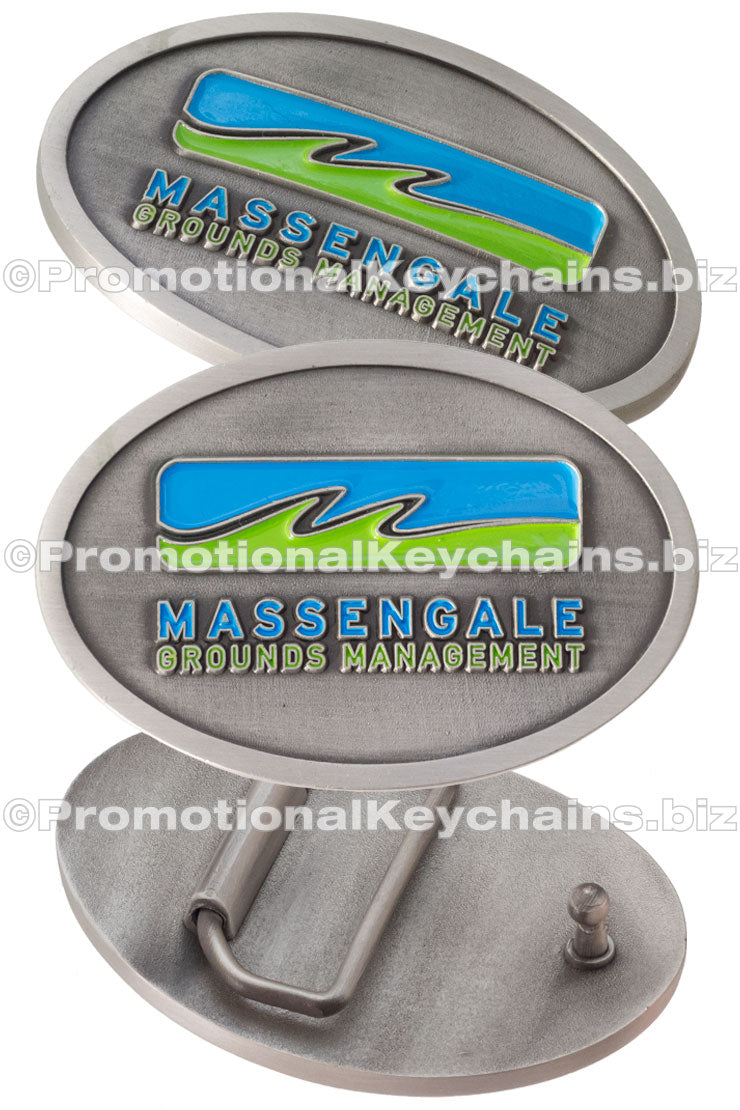 Three views of an antiqued metal belt buckle featuring a logo for Massengale Grounds Management.