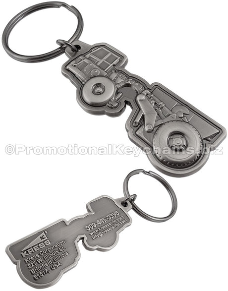 Both sides of an antiqued nickel keychain with a 3-dimensional tractor design on the front and the Kress Corporation's logo and contact info on the reverse side.