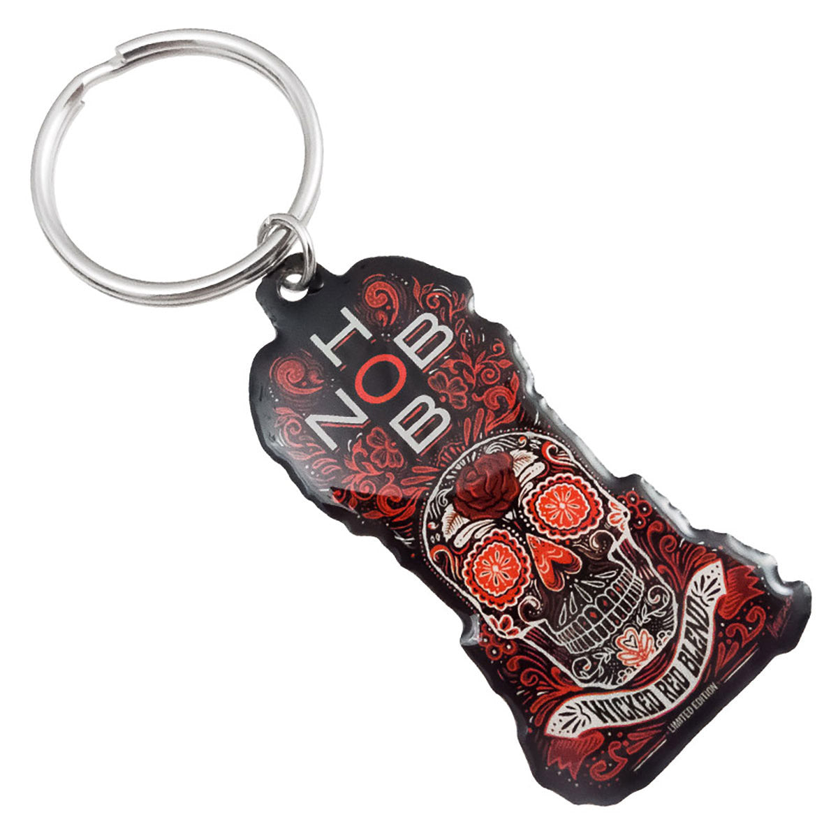 A colorful keychain featuring a skull design, "HOB" and "Wicked Red Blend" text, adorned with floral accents in various shades of red, black, and orange.
