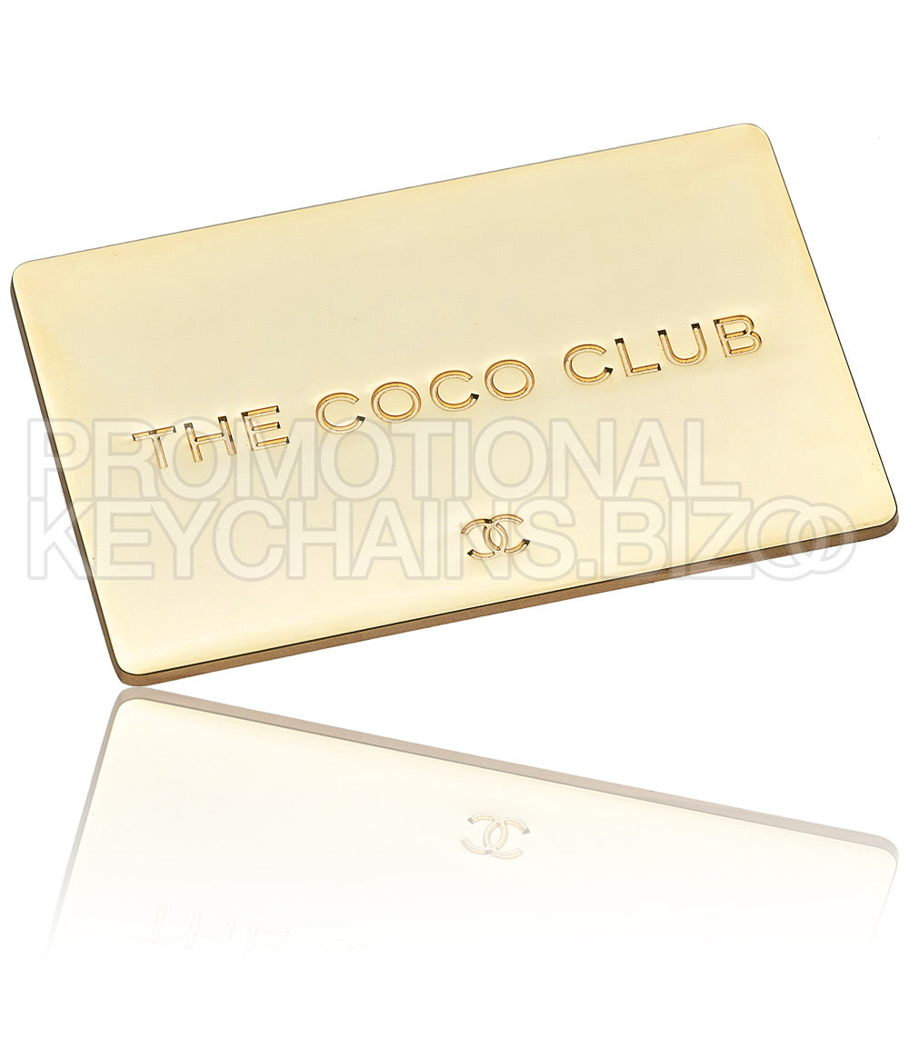A sleek, rectangular, polished gold plate with the text "THE COCO CLUB" centered and a small Chanel logo underneath.