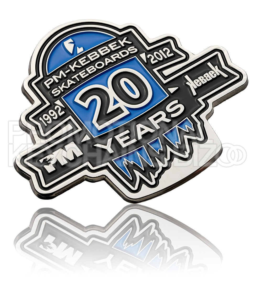 A 20th anniversary polished nickel plate for PM-Kebbek Skateboards, featuring the years 1992 to 2012 with blue and black enamel color.