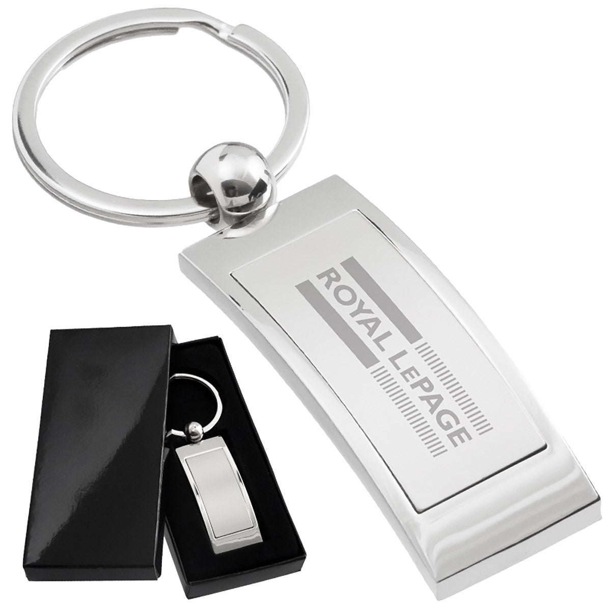 There are two images. On the left, a polished metal keychain, rectangular in shape, displayed in a black gift box. On the right is the same keychain with a logo clearly engraved in the center.