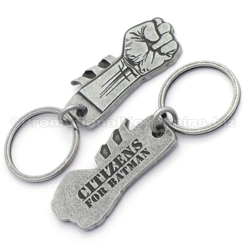 The front and back an antiqued nickel keychain featuring a clenched fist design on the front with "Citizens for Batman" debossed on the backside.