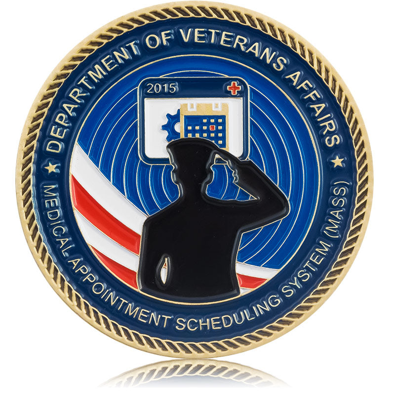 A commemorative soft enamel coin plated in brass for the Department of Veterans Affairs, featuring a silhouetted soldier saluting on a background of blue enamel color and a rope border around the edge.