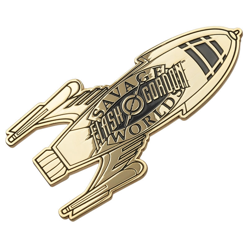 A polished brass plate featuring a retro spaceship design with "Flash Gordon" branding at its center in black enamel color.