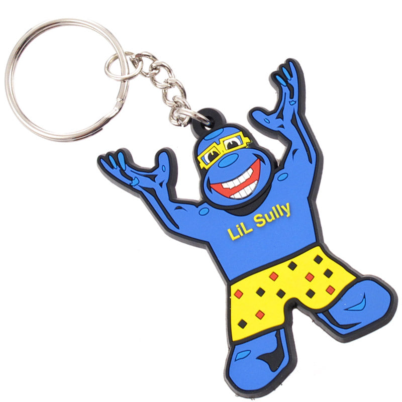 A black PVC keychain with a blue cartoon character named "LiL Sully" wearing yellow swim trunks and goggles, joyfully raising its arms.