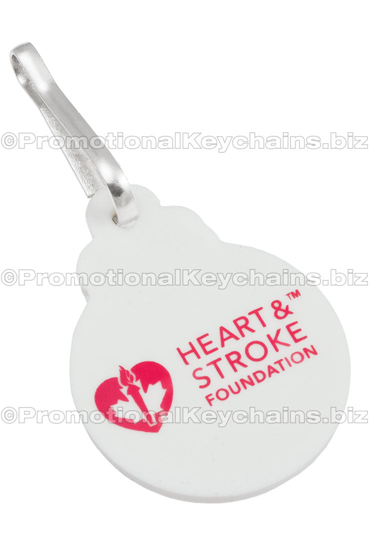 The flat, reversed side of a PVC zipper pull with a custom screen printed logo in red ink.