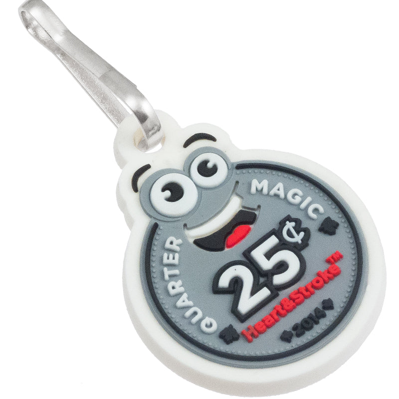 A PVC zipper pull featuring a smiling cartoon coin in white, black, grey, and red.