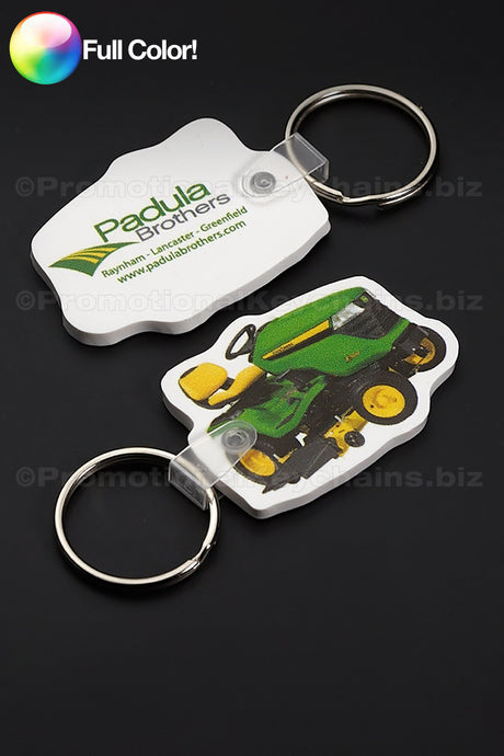 Two keychains printed in full color, one with a photo of a tractor and the other side showing the logo of the Padula Brothers company.