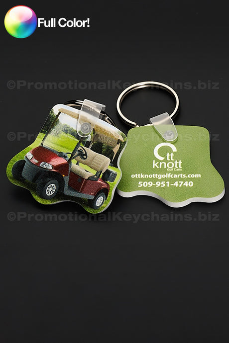 Two colorful vinyl keychains in the shape of a golf cart with a photo of the cart and OTT Knott logo against a dark background.
