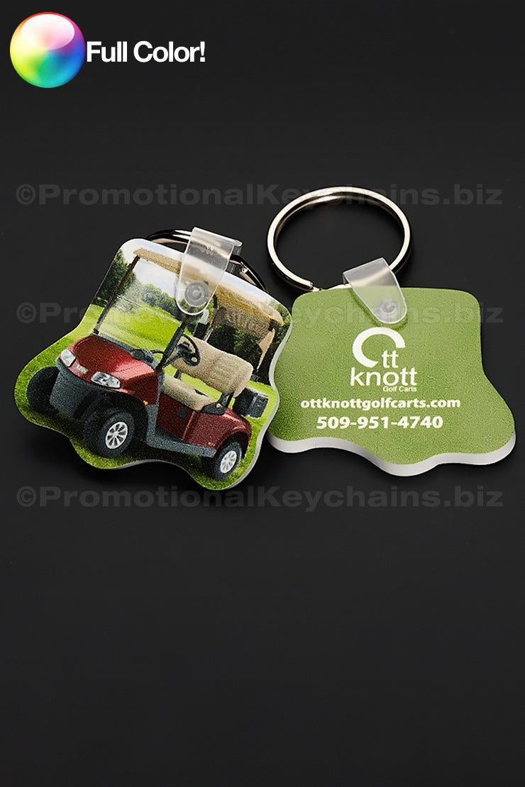 Two colorful vinyl keychains in the shape of a golf cart with a photo of the cart and OTT Knott logo against a dark background.
