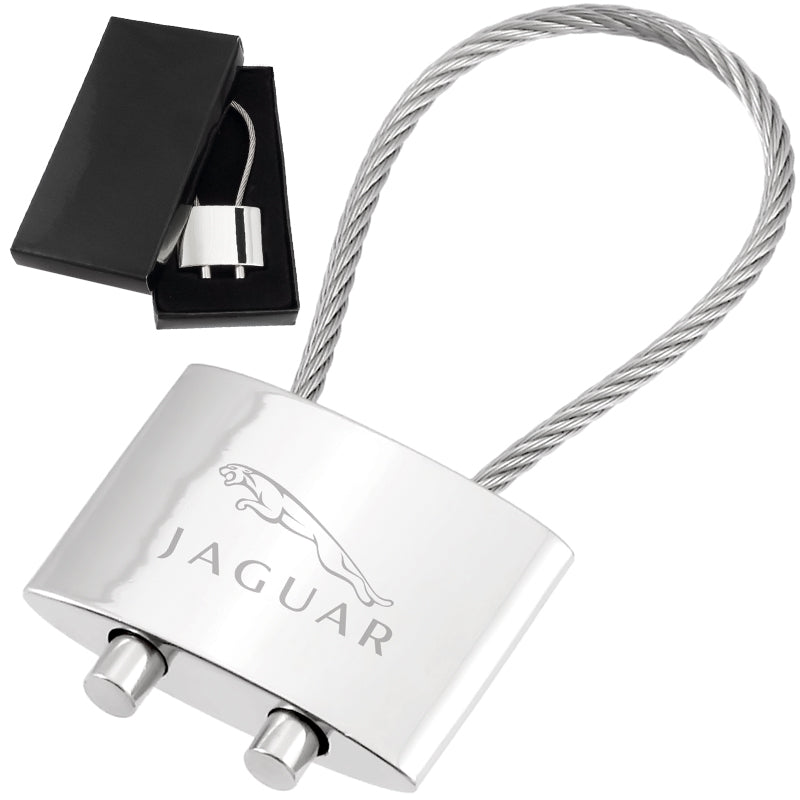There are two images. On the left, a polished metal cable keychain displayed in a black gift box. On the right is the same keychain with a logo clearly engraved in the center.