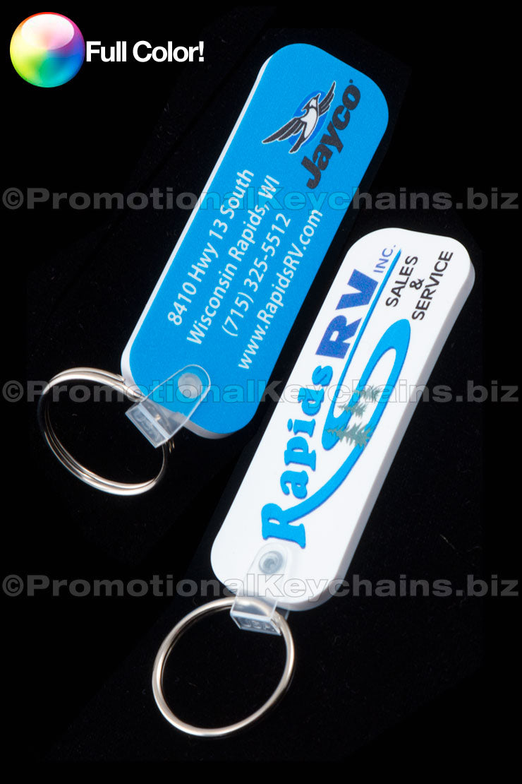 Two long rectangle vinyl keychains with full color imprinting. One keychain is blue with white text and is the front, and the other is the back and has white with blue text, with a promotional message and the company website URL.