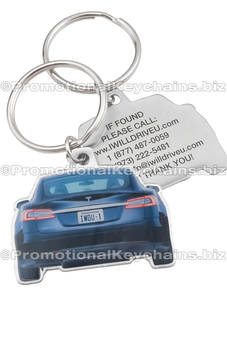Two sides of a car-shaped stainless steel keychain, featuring a blue Tesla car image with a license plate "IWDU-1" on one side and contact information printed in black on the other.