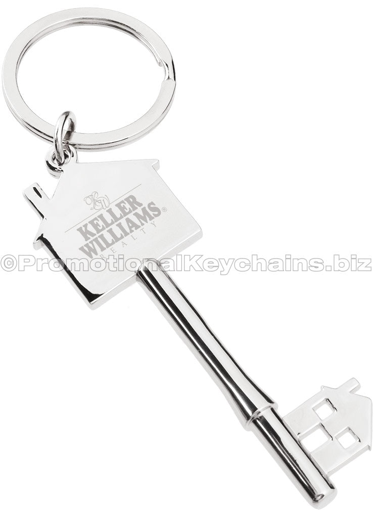 A polished key-shaped keychain featuring a house silhouette with the "Keller Williams" logo engraved on the head.
