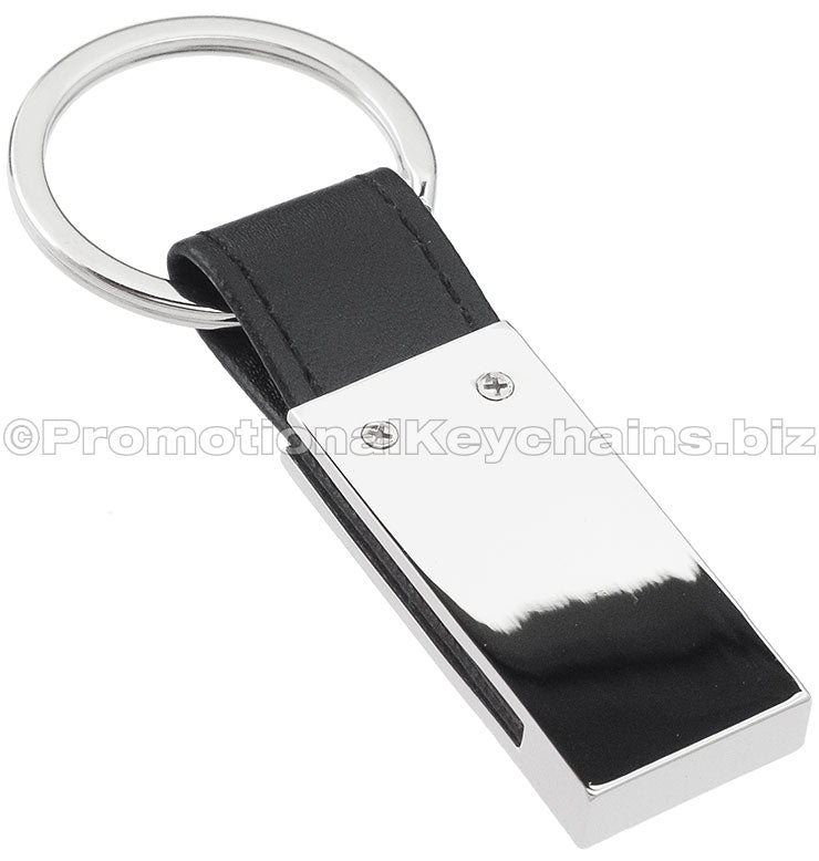 The blank back of a rectangular polished metal keychain featuring a leather strap attachment.