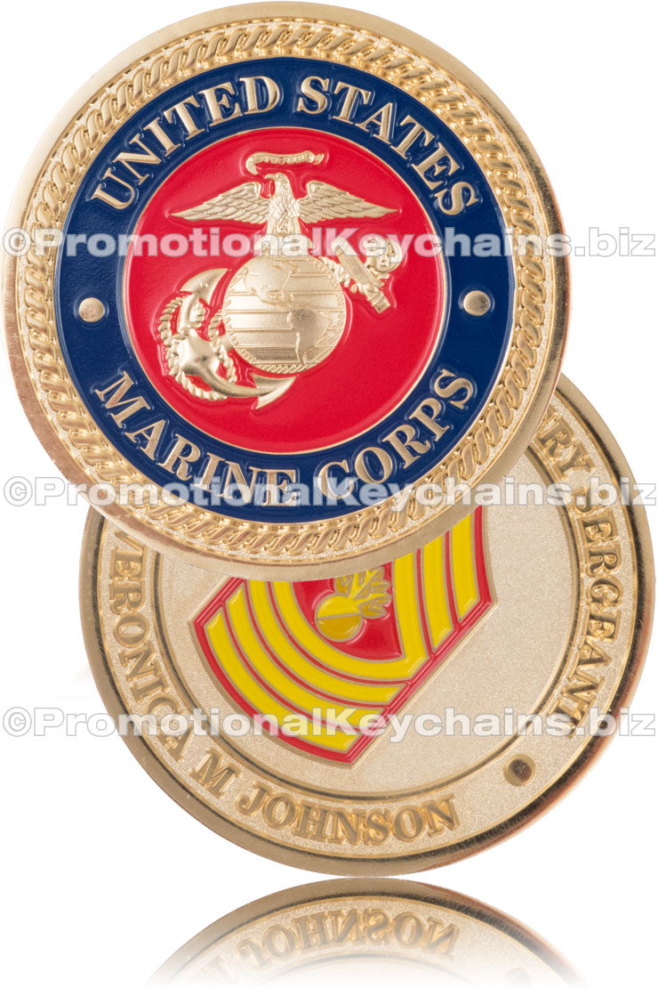 The front and back of a military-themed challenge coin, plated in polished gold, featuring the United States Marine Corps emblem on the front and a red and yellow rank insignia on the back.