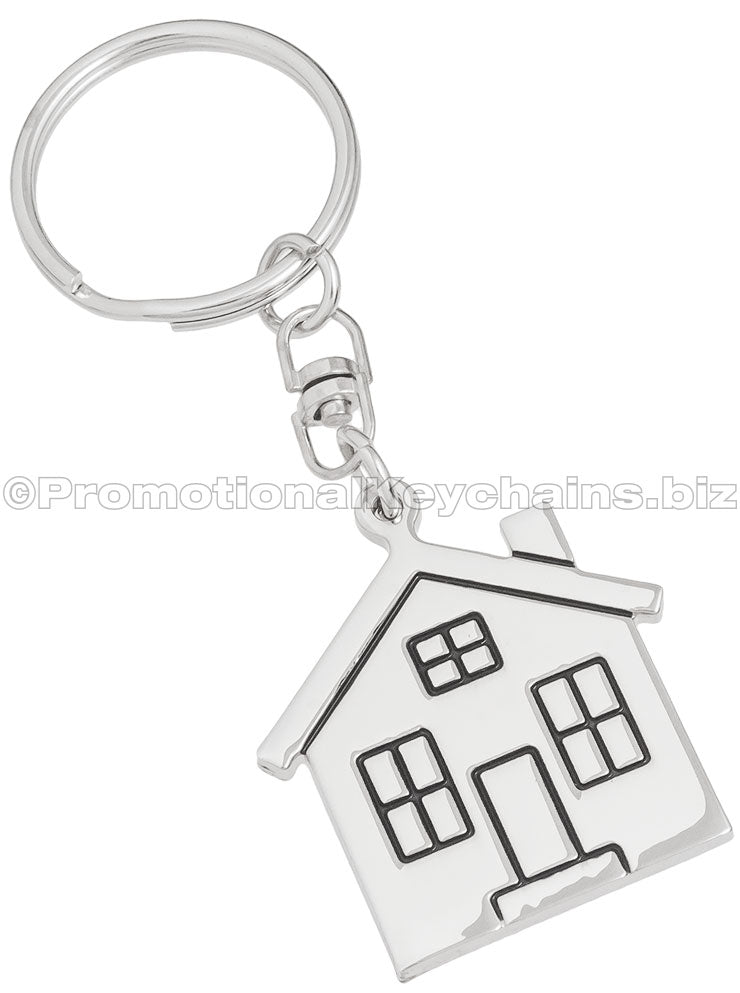 A polished metal keychain in the shape of a house.