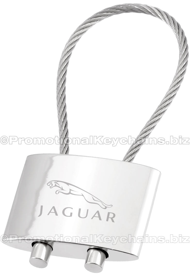 A polished metal cable keychain featuring an engraving of the Jaguar logo.