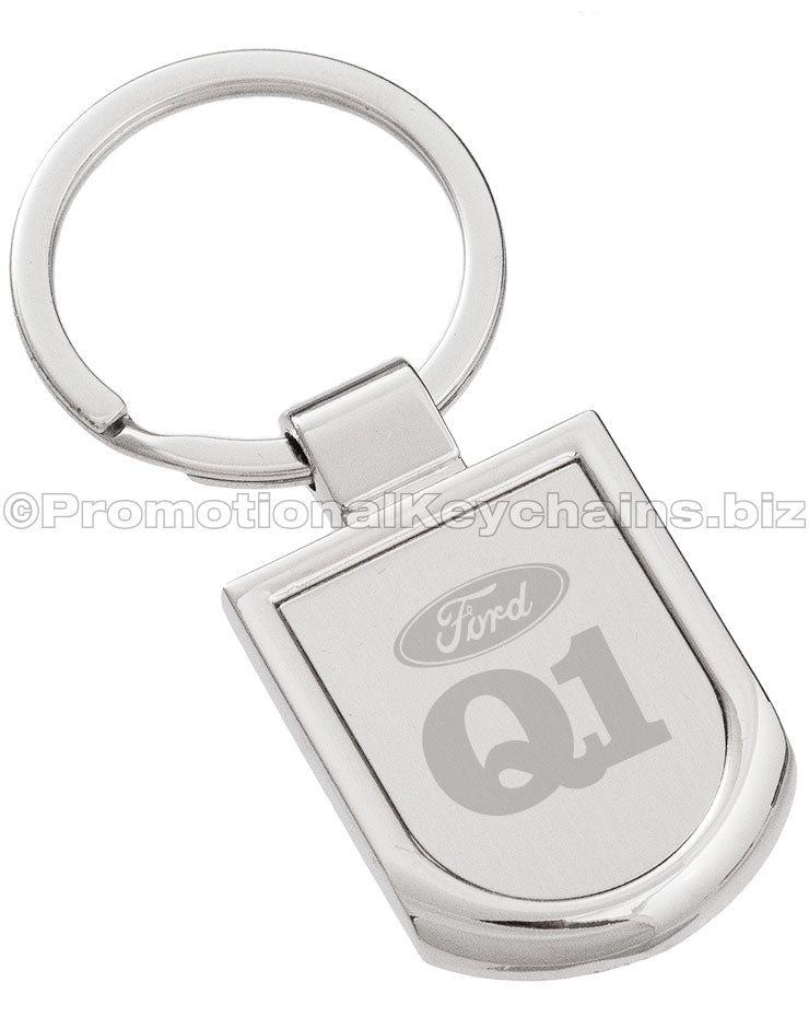 A polished silver keychain featuring a badge-shaped pendant engraved with the Ford logo and "Q1".