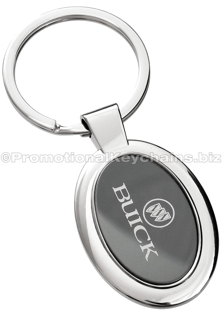 A polished metal ovular keychain featuring a black metal inlay engraved with the Buick logo.