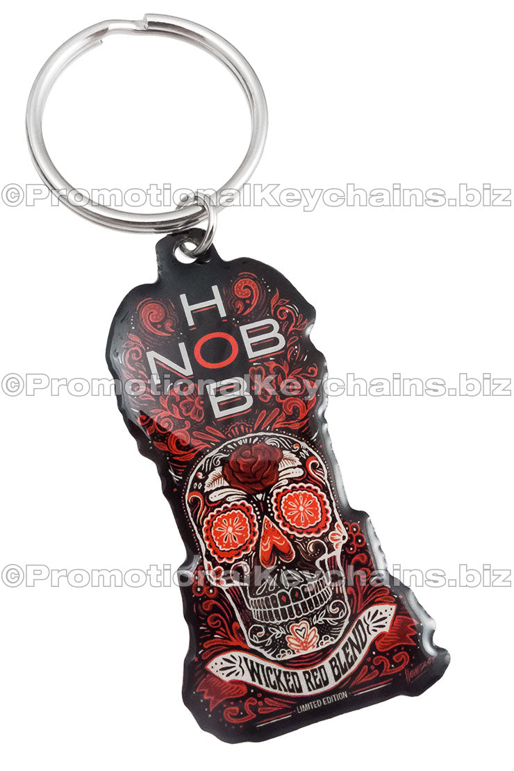 A colorful keychain featuring a skull design, "HOB" and "Wicked Red Blend" text, adorned with floral accents in various shades of red, black, and orange.