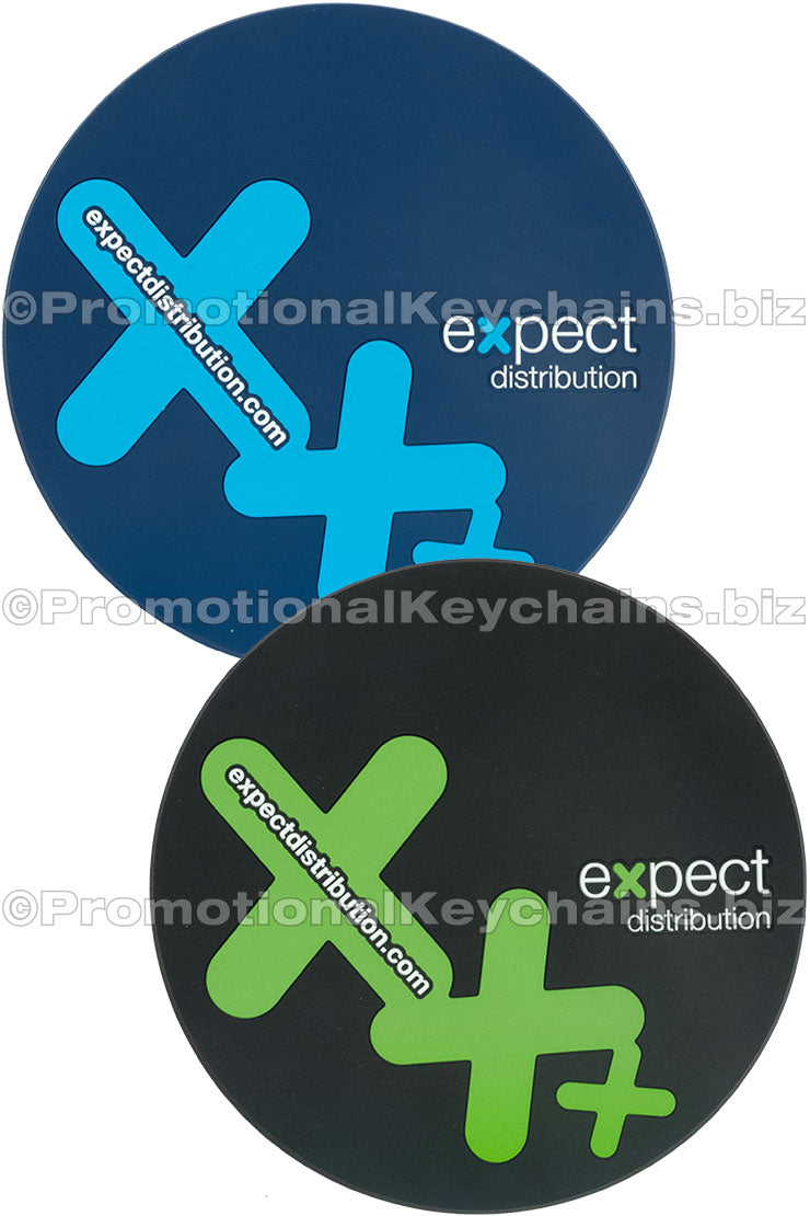 Two circular PVC coasters with the same design in two different colorways. One is blue with a light blue design and one black with a green design, both featuring branding from Expect Distribution.