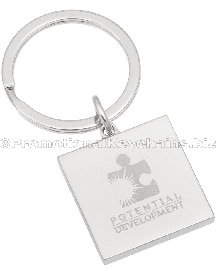 The back of a square keychain with an engraving of the logo for Potential Development.